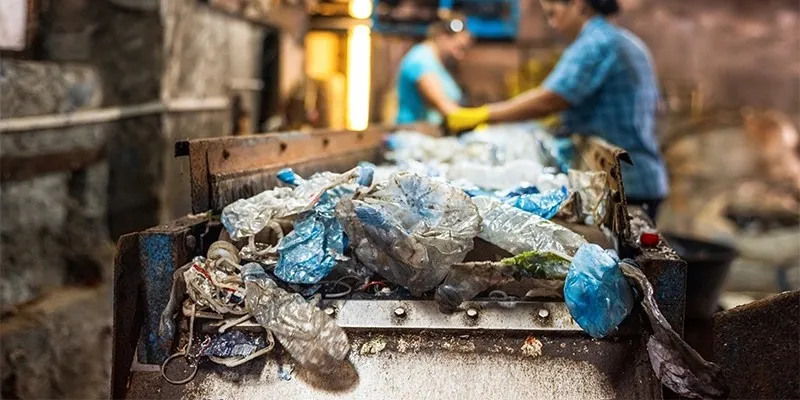 Scrap recycling process with workers sorting plastic materials on a conveyor belt - The Process of Scrap Recycling